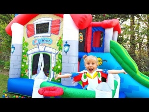 Little girl plays with dolls and builds huge inflatable houses